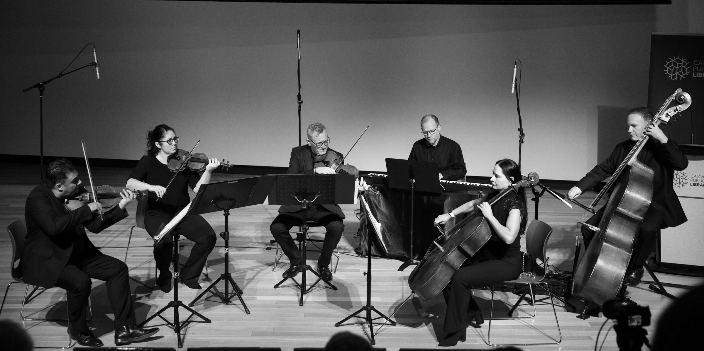 Rob Hutchinson on double bass with a string quartet and pianist on stage